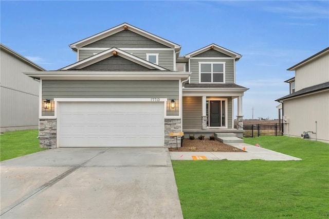 craftsman inspired home with a garage, a front yard, and covered porch