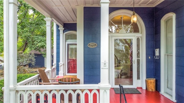 view of exterior entry with a porch