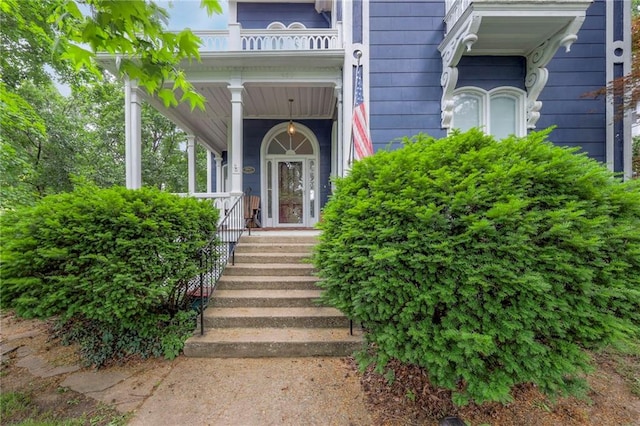 property entrance featuring a balcony and covered porch