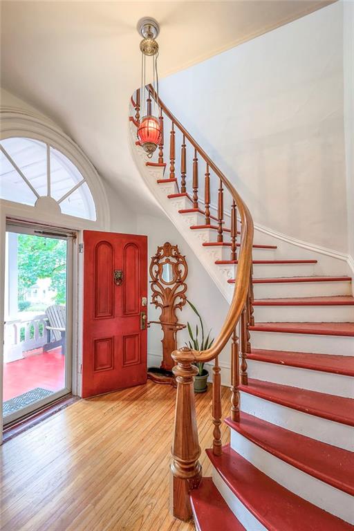 foyer entrance featuring stairway and light wood-type flooring