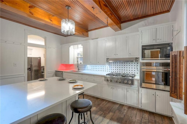 kitchen with light countertops, a sink, tasteful backsplash, stainless steel appliances, and beamed ceiling