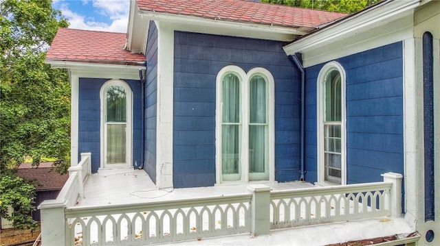 property entrance featuring a tile roof
