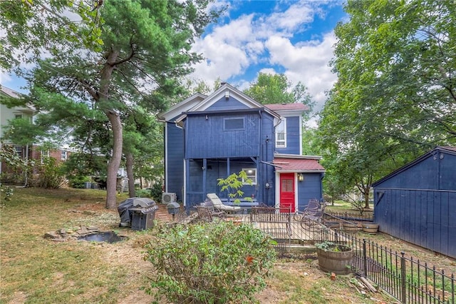 rear view of house with fence