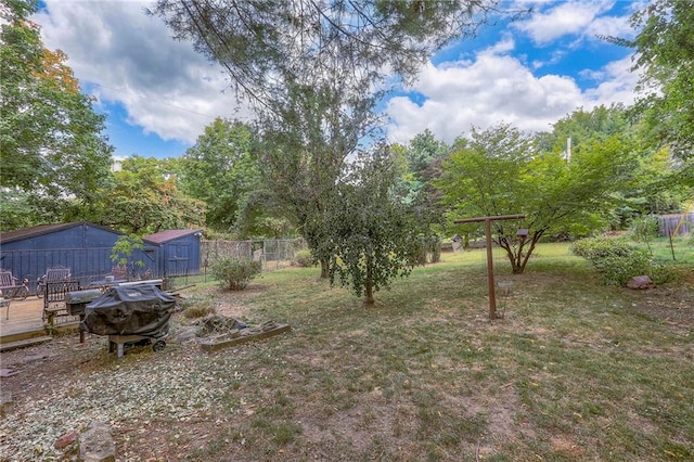 view of yard featuring a wooden deck and fence