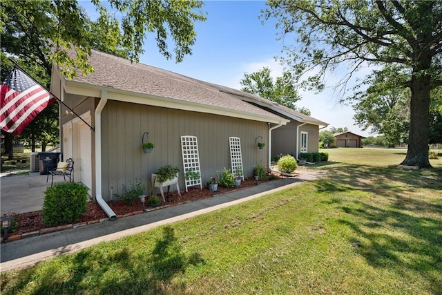 view of home's exterior with a garage and a yard