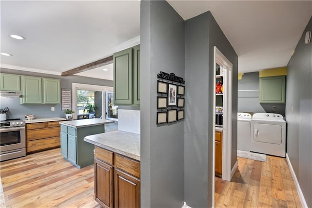 kitchen featuring stainless steel range with electric stovetop, washer and clothes dryer, and green cabinetry