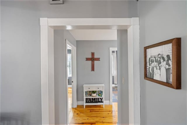 hallway with hardwood / wood-style floors