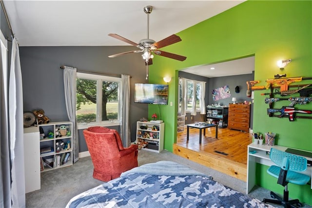 carpeted bedroom featuring lofted ceiling and multiple windows