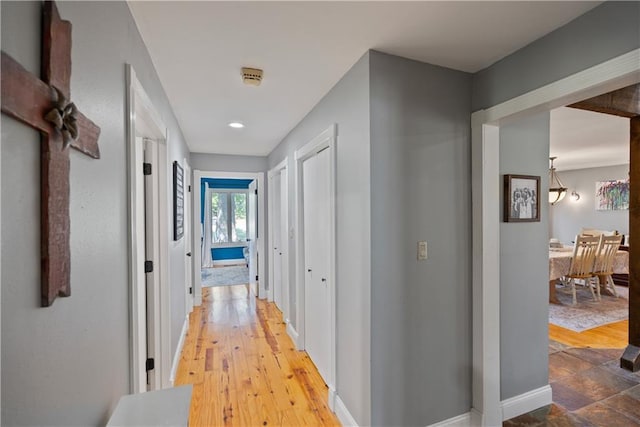 hall with hardwood / wood-style floors