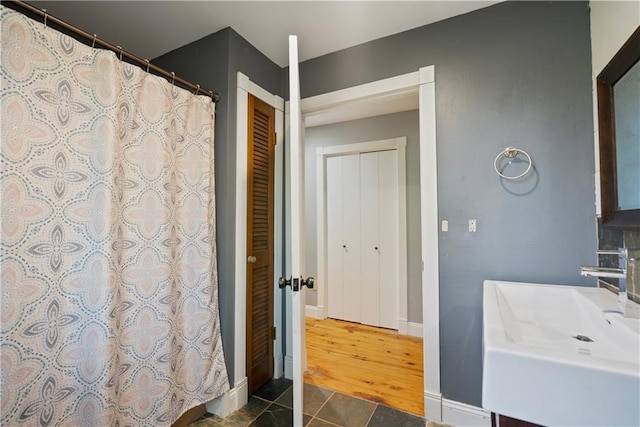 bathroom with sink, tile patterned floors, and walk in shower