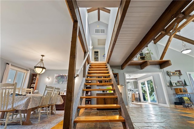 staircase featuring beamed ceiling and high vaulted ceiling