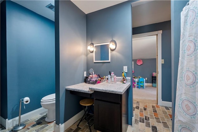 bathroom with vanity and toilet