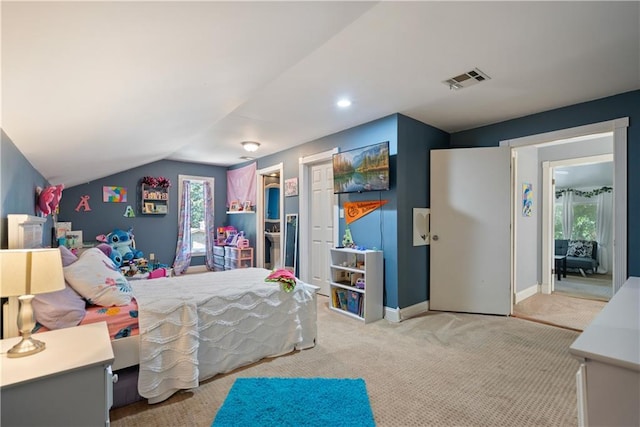 carpeted bedroom with vaulted ceiling