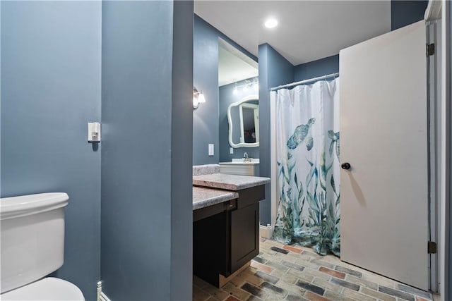 2924 Crown Dr, Independence, KS 67301 - full bath with brick flooring, vanity, and a shower with curtain