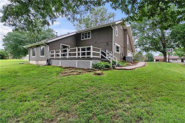 2924 Crown Dr, Independence, KS 67301 - rear view of house with a wooden deck and a lawn