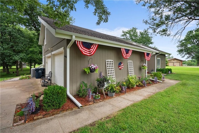 2924 Crown Dr, Independence, KS 67301 - view of side of property featuring a lawn, concrete driveway, and a garage