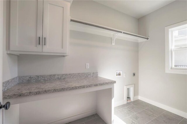 laundry area featuring hookup for a washing machine, cabinet space, baseboards, and electric dryer hookup