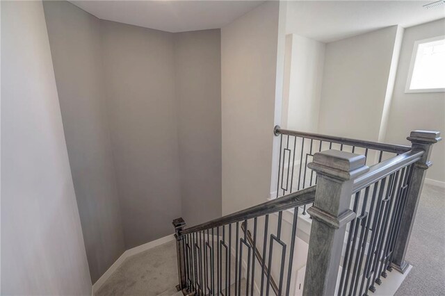 staircase featuring carpet floors, visible vents, and baseboards