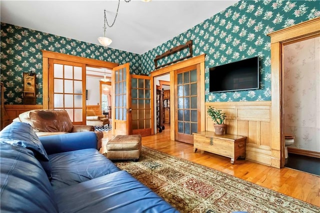 living room featuring french doors and light wood-type flooring