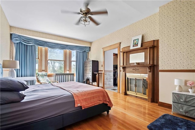 bedroom with ceiling fan and hardwood / wood-style flooring