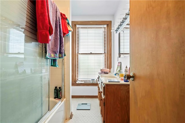 bathroom with vanity, tile patterned flooring, and enclosed tub / shower combo