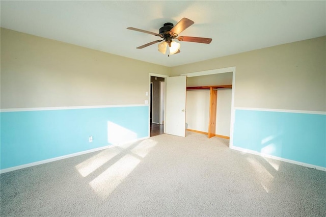 unfurnished bedroom featuring carpet floors, a closet, and ceiling fan