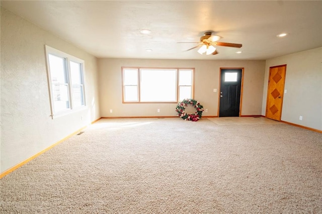 unfurnished living room with carpet flooring and ceiling fan