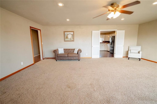 sitting room featuring ceiling fan and carpet floors