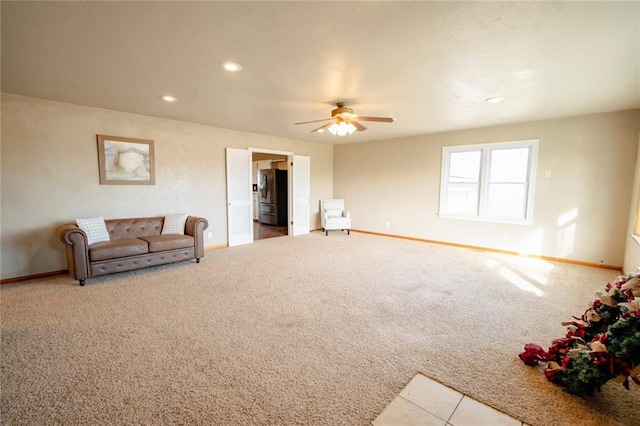 carpeted living room featuring ceiling fan