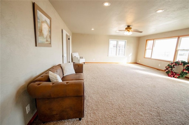 carpeted living room featuring ceiling fan