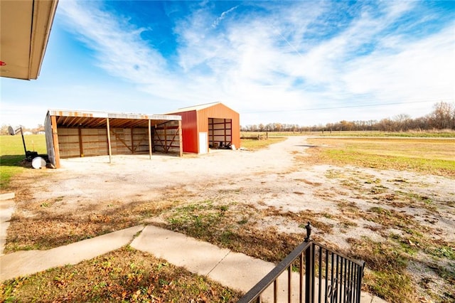 view of yard with a rural view and an outbuilding