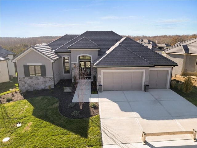 single story home with french doors, a front lawn, and a garage