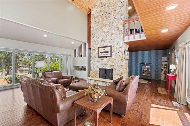 living room with a stone fireplace, dark wood-type flooring, high vaulted ceiling, and wooden ceiling