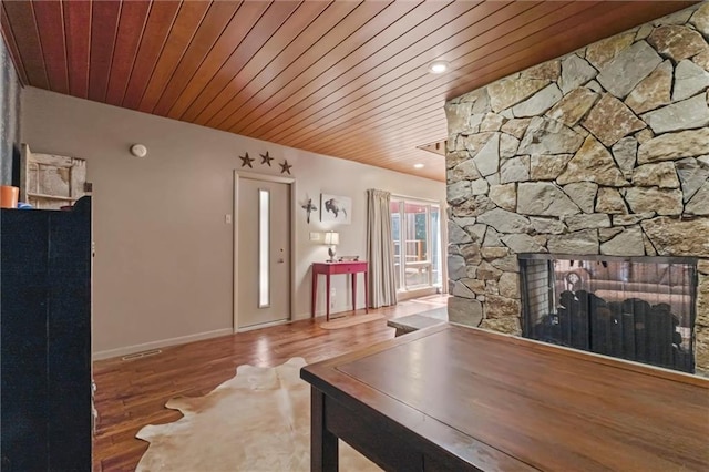 unfurnished living room with hardwood / wood-style floors, a fireplace, and wood ceiling