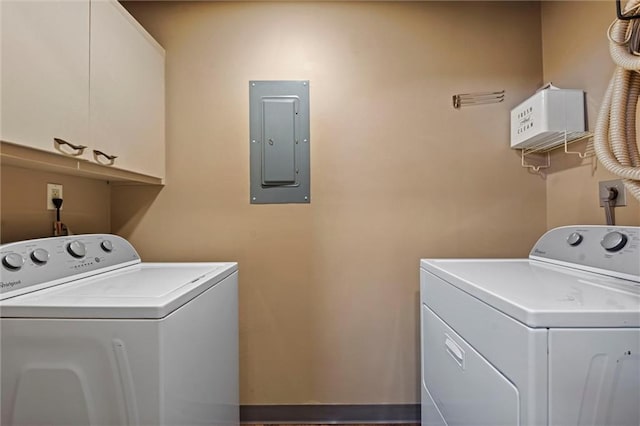 laundry area featuring cabinets, washer and clothes dryer, and electric panel