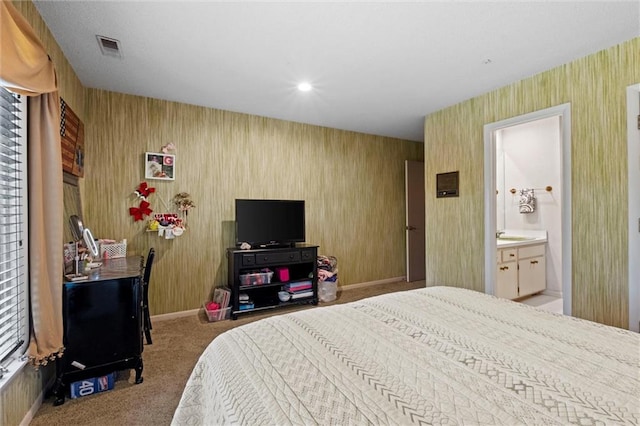 carpeted bedroom featuring ensuite bathroom