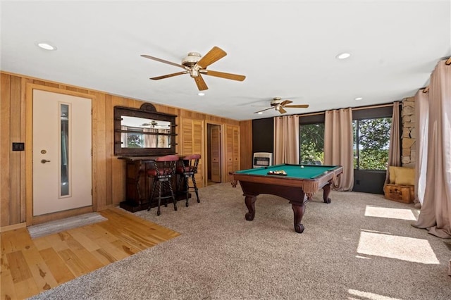 rec room with pool table, light colored carpet, wooden walls, and ceiling fan