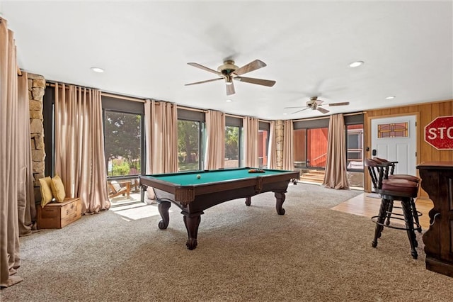 playroom featuring pool table, light carpet, ceiling fan, and wooden walls