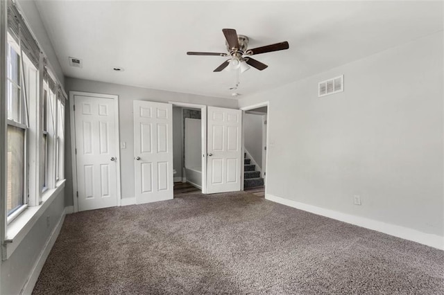 unfurnished bedroom featuring carpet flooring and ceiling fan