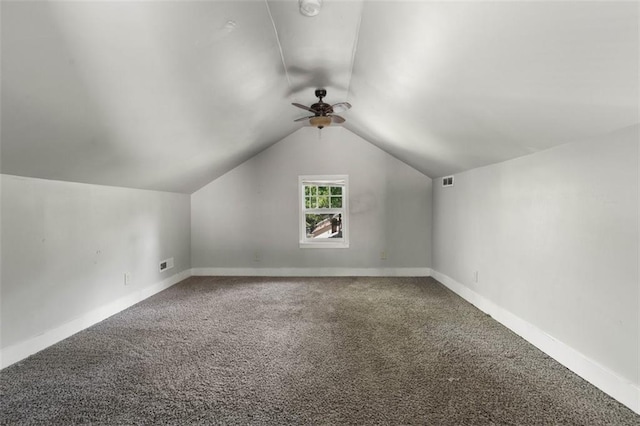 additional living space featuring carpet, lofted ceiling, and ceiling fan