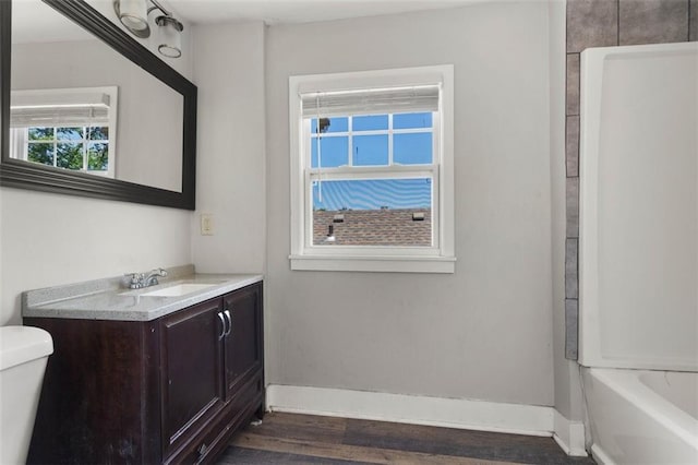 bathroom featuring vanity, toilet, and hardwood / wood-style floors