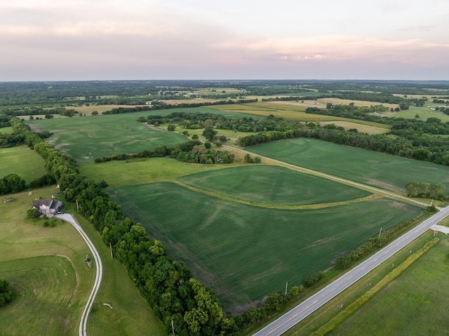 aerial view at dusk featuring a rural view