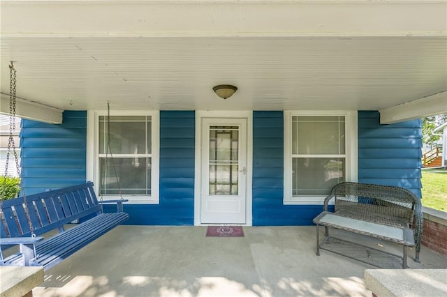 entrance to property featuring covered porch