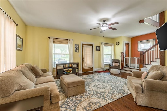 living room featuring wood-type flooring and ceiling fan