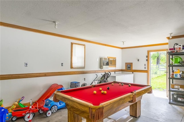 game room with billiards, a textured ceiling, and crown molding