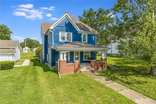 view of front of house with a front yard and covered porch