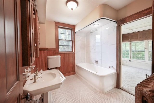 full bathroom featuring tiled shower / bath combo, toilet, and sink