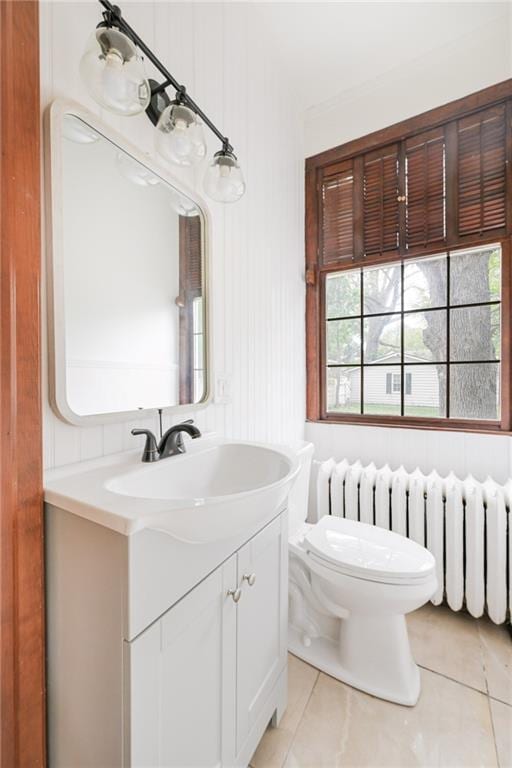 bathroom featuring vanity, toilet, tile patterned floors, and a wealth of natural light