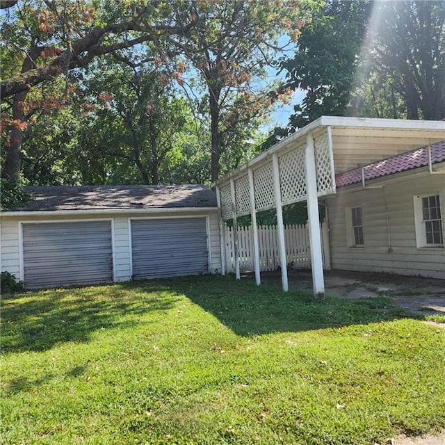 view of home's exterior featuring a garage and a lawn