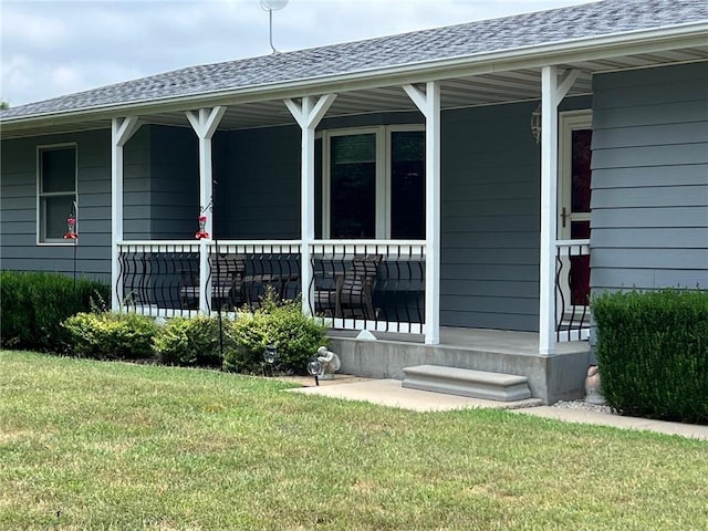 property entrance with a lawn